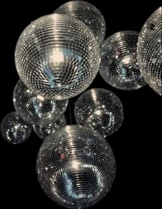 several shiny disco balls hanging from the ceiling