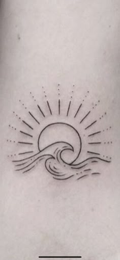 a woman's stomach with the sun and waves tattoo on it