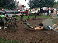 people are playing with sculptures in the park