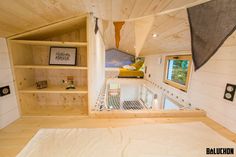 the interior of a tiny house with shelves and bookshelves