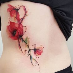 a woman's stomach with flowers painted on it