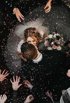 the bride and groom are surrounded by confetti