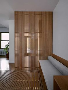 an empty room with wooden slats on the wall