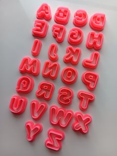 letters and numbers made out of plastic on a white surface with the letter's lowercases