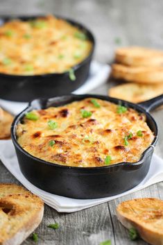 two black pans filled with cheesy bread