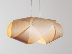 a wooden light fixture hanging from a ceiling with two strings attached to the lightshade