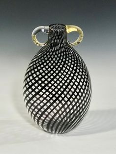 a black and white vase sitting on top of a table