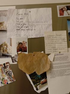 a bulletin board covered in pictures and papers with writing on it's back side