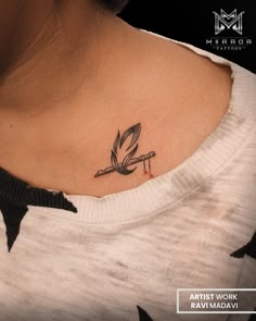 a woman with a small tattoo on her neck