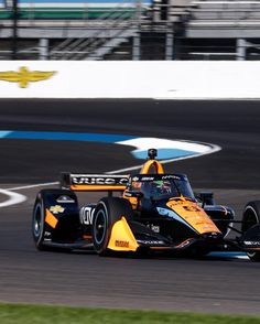 a man driving a race car on a track