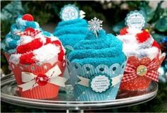 three cupcakes decorated with red, white and blue frosting on a cake plate