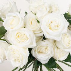 a bunch of white roses in a vase