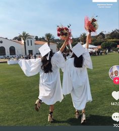 two girls in white graduation gowns holding flowers on their heads while walking across a field