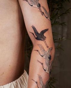 a man's arm with birds on it