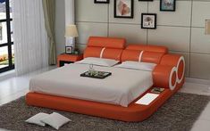 an orange and white bed sitting on top of a carpeted floor next to a window