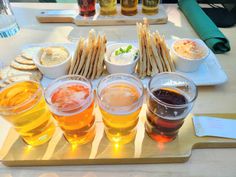 there are many different foods and drinks on the table with it's serving platter