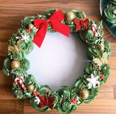 a christmas wreath shaped cake on a wooden table