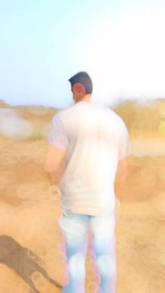 a blurry image of a man standing in the desert