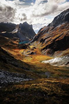 the mountains are covered in yellow and brown grass