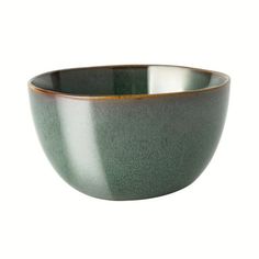 a green and gold bowl on a white background