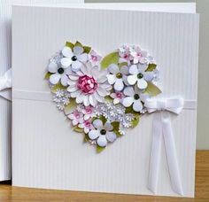 a heart shaped card with flowers on it