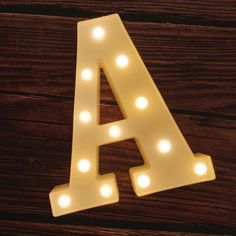 a light up letter sitting on top of a wooden table