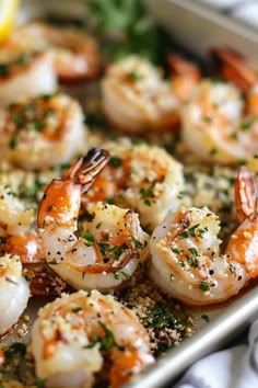 cooked shrimp with parsley and lemon on a baking sheet