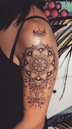 a woman's arm with a tattoo on it and an intricate design in the middle