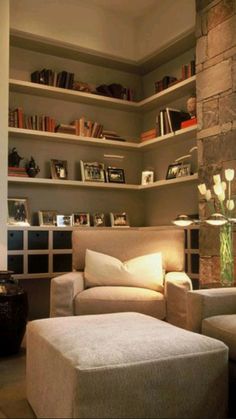 a living room filled with furniture and bookshelves