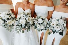 four bridesmaids in white dresses holding bouquets