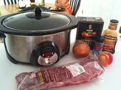 an electric pressure cooker with meat, potatoes and other food items on the table