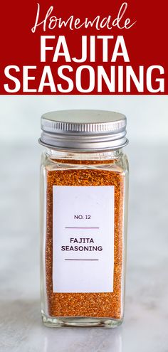 a glass jar filled with taco seasoning on top of a counter