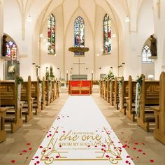 an aisle decorated with red roses and gold lettering