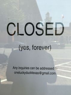 a close up of a window with a sign in front of it that reads closed yes, forever