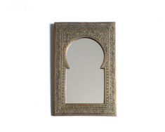 a mirror that is on the wall with a frame around it's edges and an arch in the middle