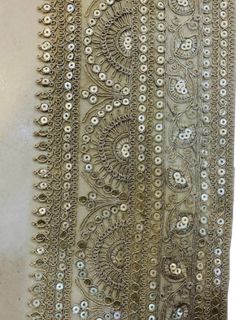 an embroidered fabric with beads and sequins