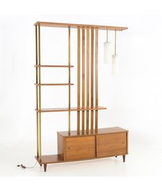 a wooden shelf with two lamps hanging from it's sides and a cabinet below