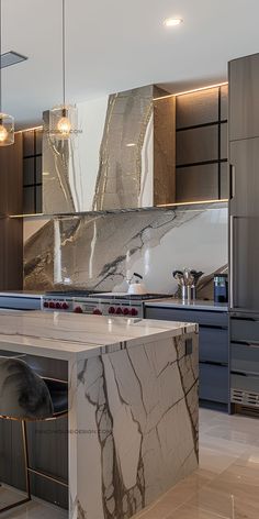 a kitchen with marble counter tops and an island in front of the stove top oven