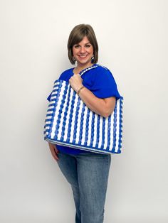 Add some serious sass to your beach game with our Summer Tote Bags. With two color options, this woven bag is the perfect accessory for a day by the water. Stay stylish and organized while carrying all your beach essentials. (No more losing your sunglasses in the sand!) Hot pink, clear, & aruba blue Blue & white Free shipping over $100. Summer Beach Reusable Shoulder Bag, Casual Reusable Beach Bag For Shopping, Recyclable Tote Beach Bag For Vacation, Summer Beach Bag, Recyclable, Reusable Blue Beach Bag, Summer Beach Bag Recyclable, Summer Reusable Bag For Vacation, Summer Travel Beach Bag Made Of Plastic, Blue Recyclable Beach Bag For Summer