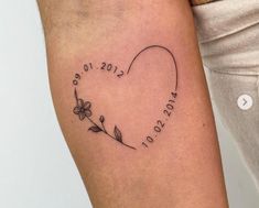 a woman's arm with a heart shaped tattoo on it