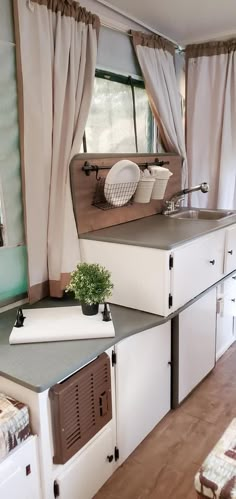 a kitchen area with sink, stove and cabinets in it's own houseboat