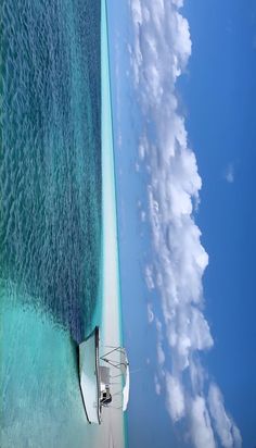 an aerial view of the ocean and clouds