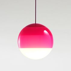 a pink and white light hanging from a ceiling