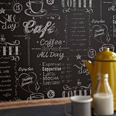 a chalkboard wall with writing on it and a yellow coffee pot next to it