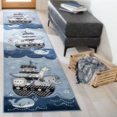 a blue area rug with boats and ships on it in the middle of a living room