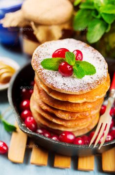 fresh cranberry pancakes with powdered sugar and mint - stock photo - images