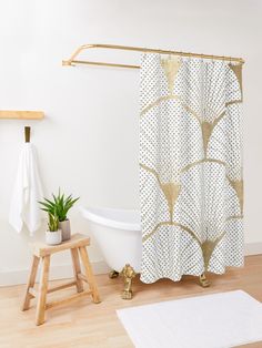 a white bath tub sitting next to a wooden stool and shower curtain in a bathroom