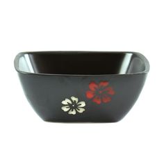 a black bowl with red and white flowers on the side, sitting in front of a white background