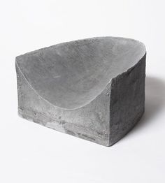 a stone bowl sitting on top of a white table