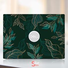 the dell laptop is green with gold leaves on it's back and white logo